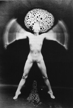 a surreal-style photograph of a naked body in the pose of the Vitruvian man